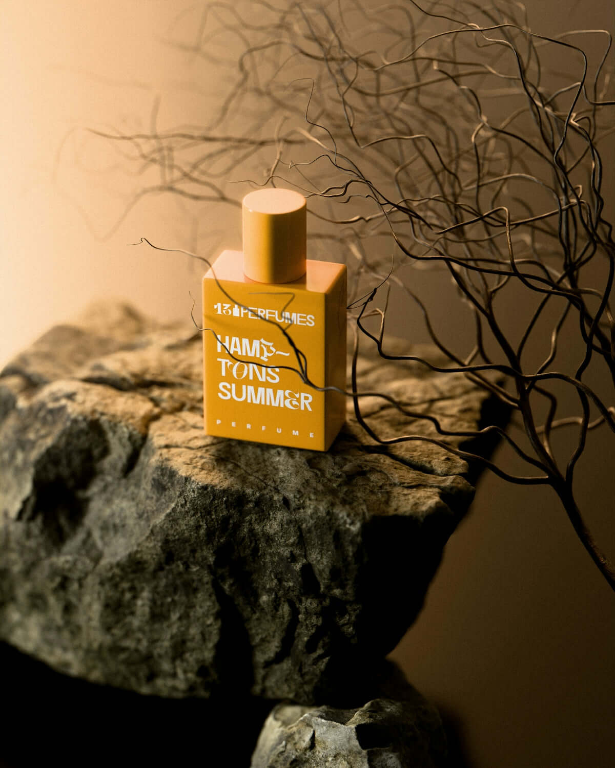 amber soy candle handmade A perfume bottle sits atop a rugged rock.