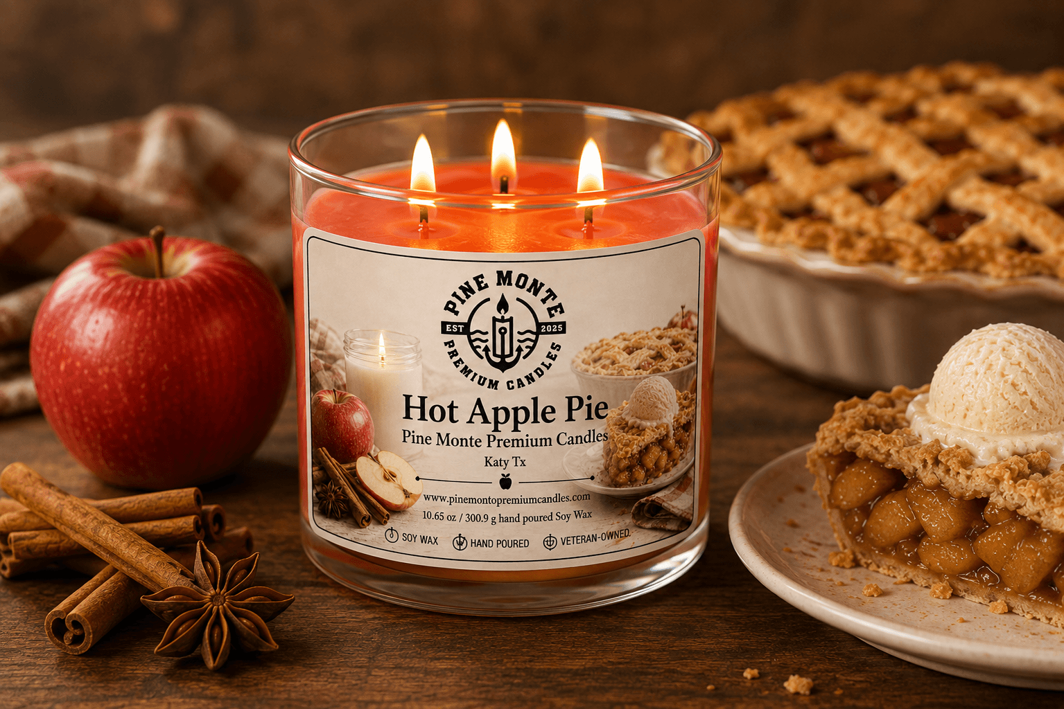 Hot Apple Pie Soy Candle in a glass jar with apple, cinnamon sticks, and a apple pie in the background.