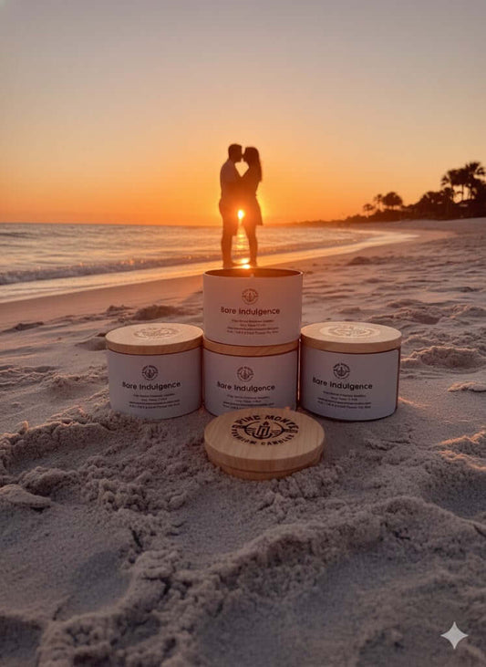 3 wick bare indulgence soy candle displayed on the beach during sunset with a couple silhouette in the background.