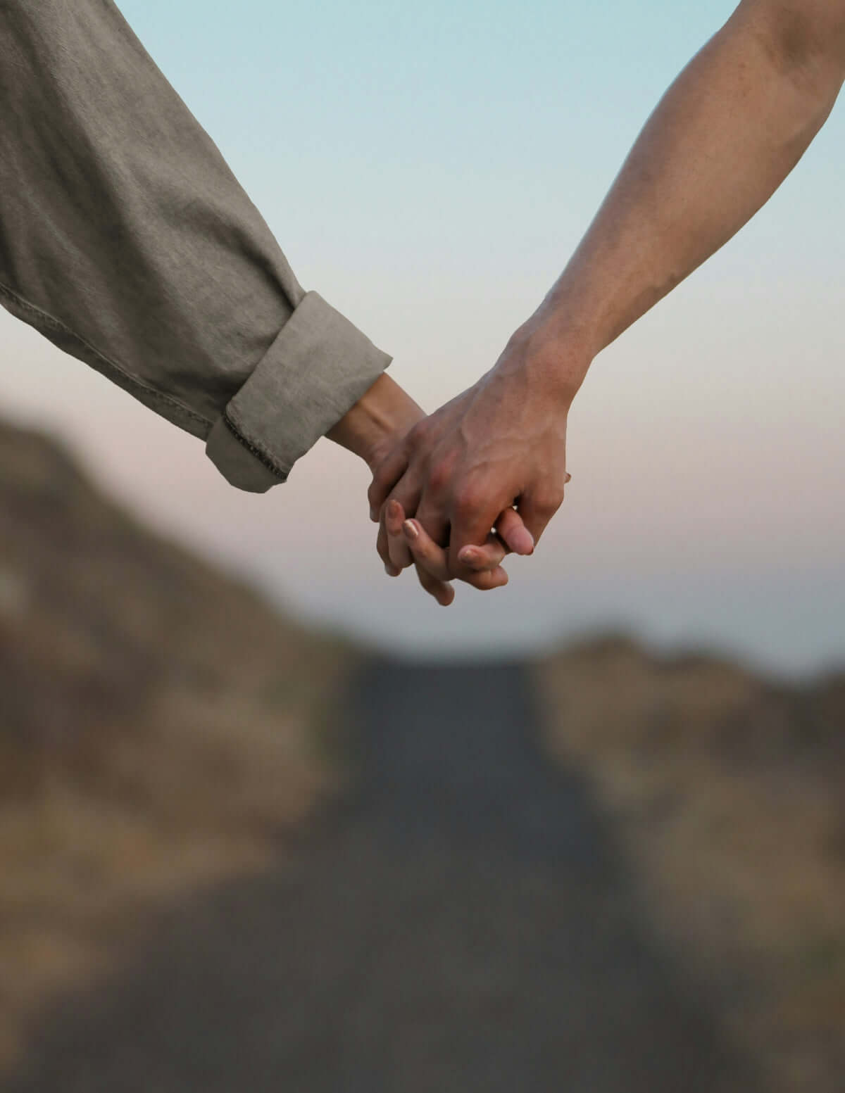 luxury scented soy candles Two people holding hands together in a scenic outdoor setting, symbolizing love and connection.