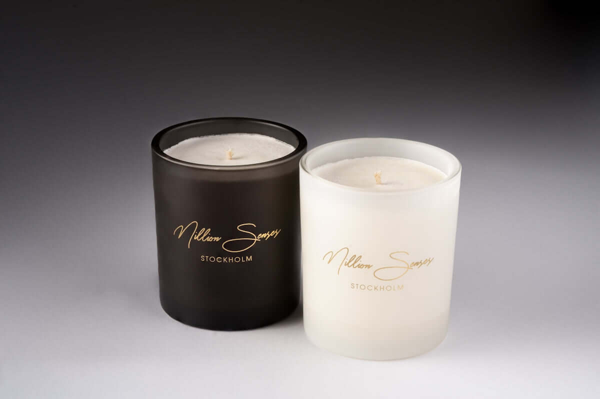 luxury scented custom candles Two scented candles with gold labels on a gray background