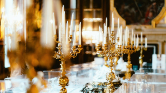 A table topped with lots of gold candles