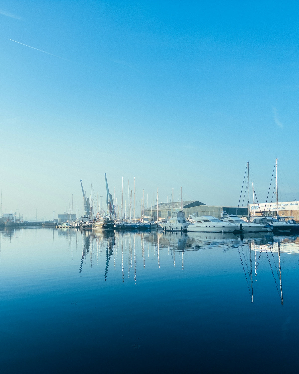 A harbor filled with lots of boats under a blue sky