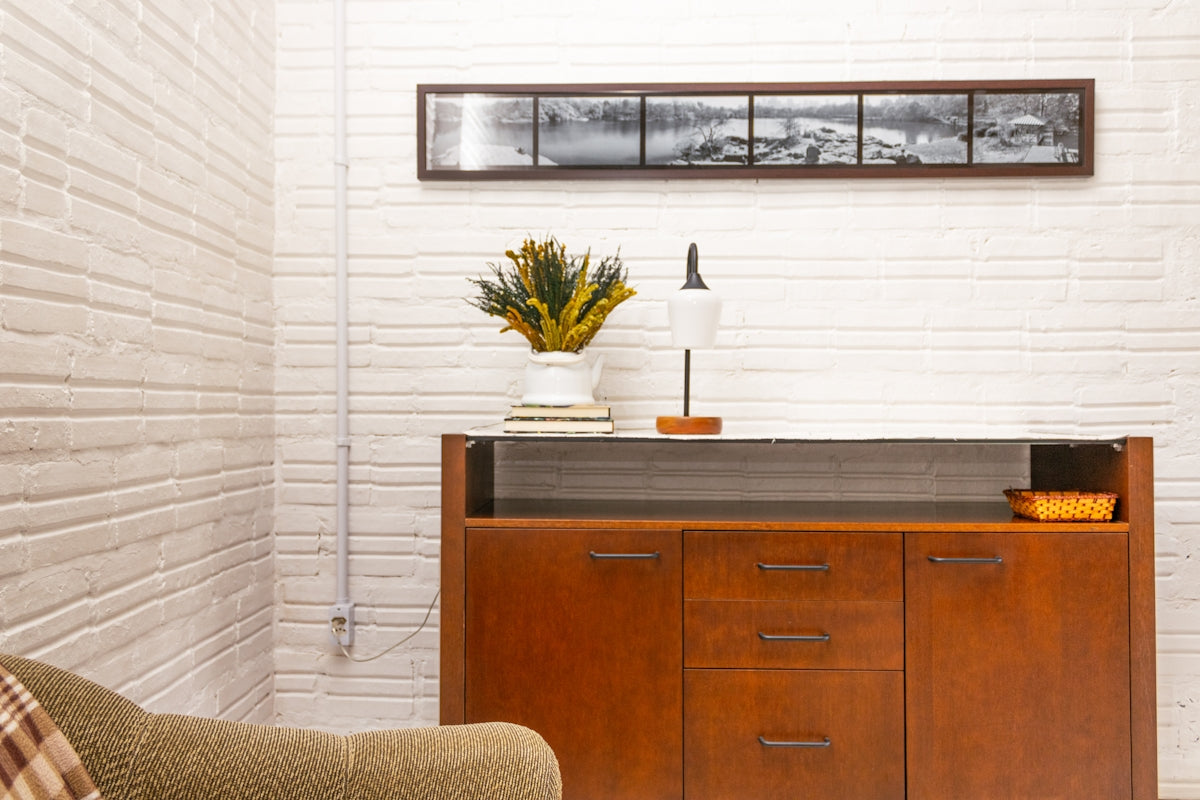 Wooden cabinet with lamp and plant