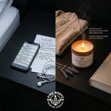 Lavender Serenity Soy Candle glowing on a bedside table with a to-do list and earbuds, promoting relaxation.