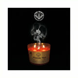 Midnight Blush Soy Candle with glowing flames and delicate smoke against a dark background.