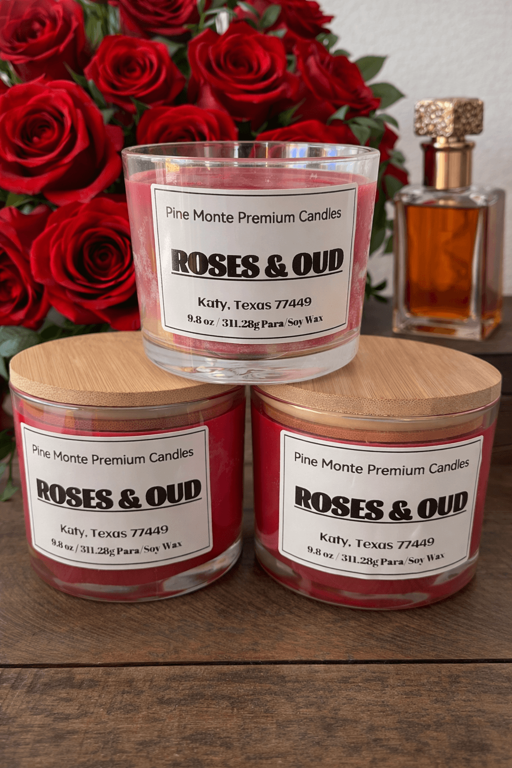 Three Roses & Oud Soy Candles with red roses in the background showcasing luxury scented candles.