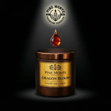 Luxury Dragon's Blood Soy Candle  with a droplet of wax above it on a dark background.