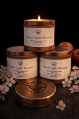 Velvet Apple Blossom Soy Candle products stacked with a warm glow, surrounded by apples and flowers.
